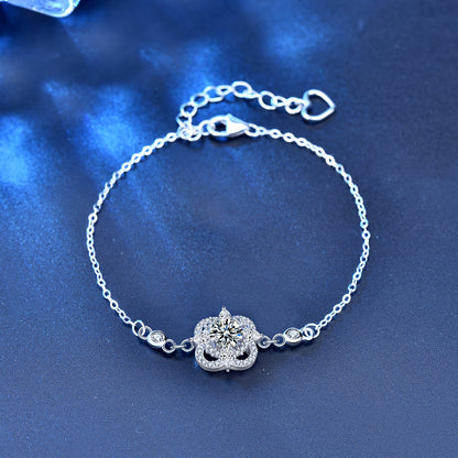 Flat-lay of four-leaf clover bracelet in sterling silver with moissanite center and CZ accents