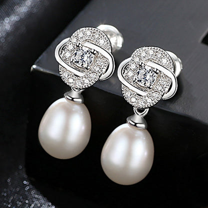 White freshwater pearl CZ dangle earrings in rhodium-plated 925 sterling silver.