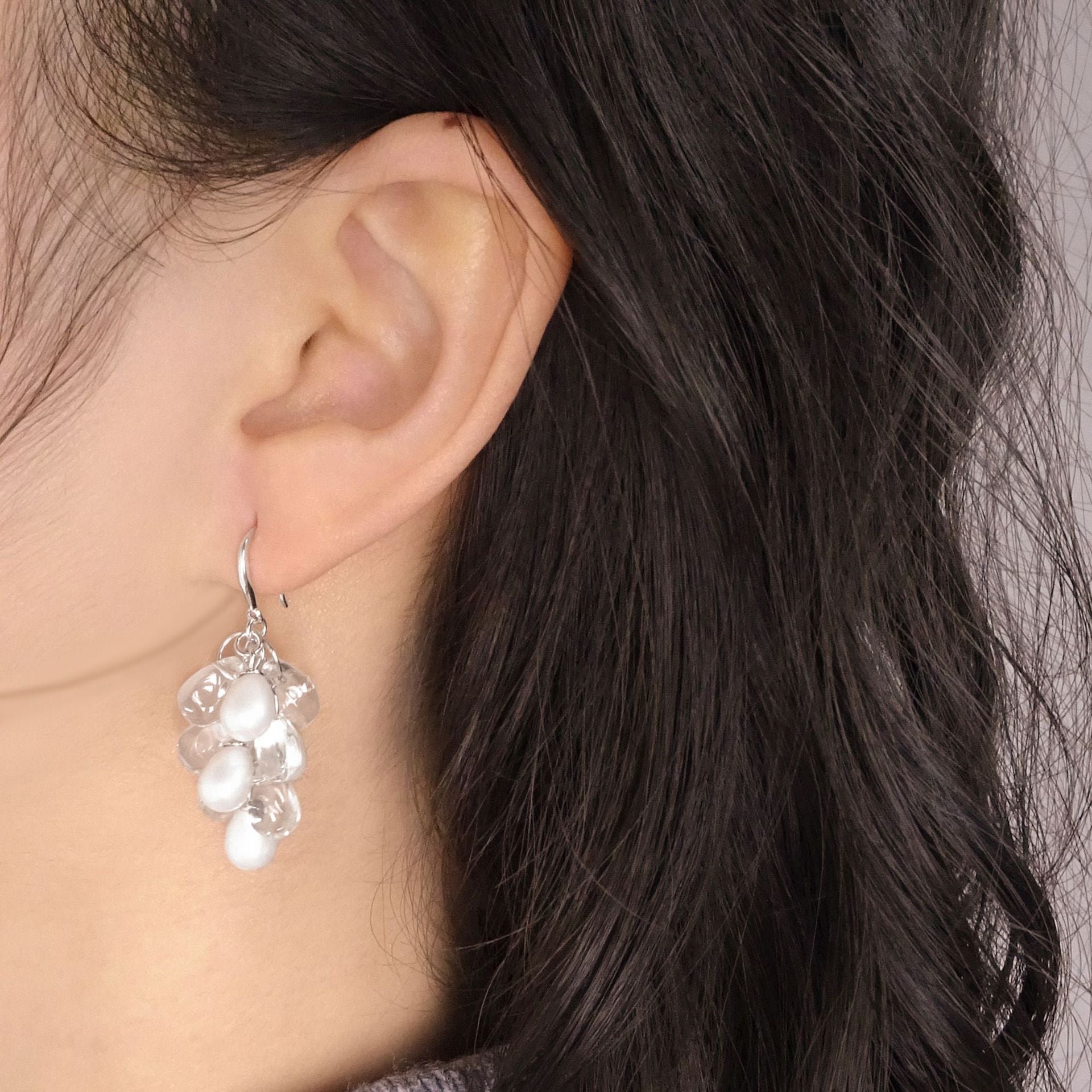 Side profile showing shell-pearl grape-cluster dangle earring on the ear, lightweight movement and shimmer.