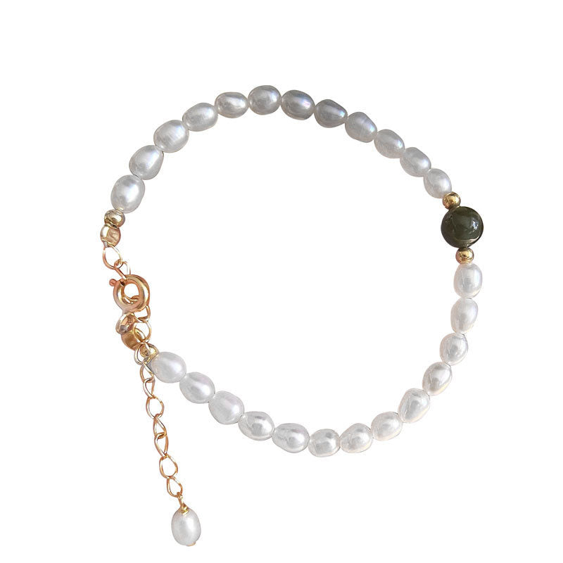 Product shot of jade and shell pearl bracelet with gold-plated clasp on white.