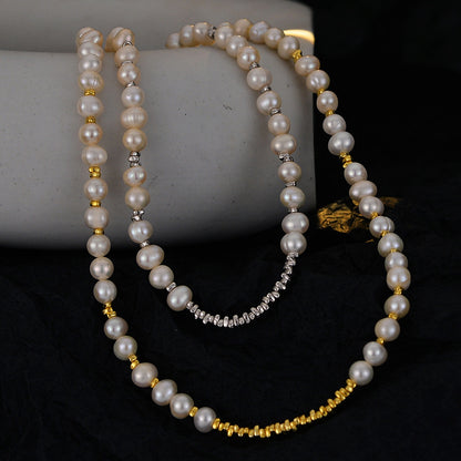 Irregular natural pearl necklaces with silver and 18K gold spacer beads draped over a stone prop