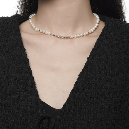 Close-up of irregular natural pearl necklace in sterling silver on a model’s neck