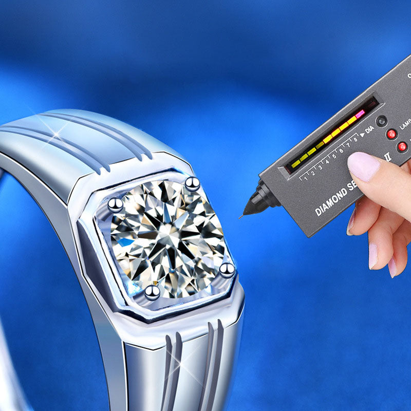 Close-up of men’s moissanite ring with a diamond tester on the center stone; octagonal bezel, rhodium-plated silver.