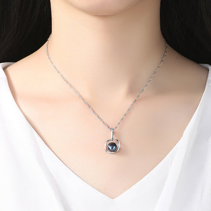 Woman elegantly wearing a pearl necklace in sterling silver