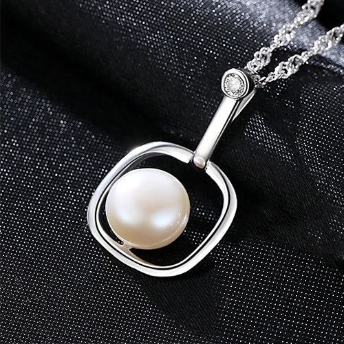 Elegant white freshwater pearl necklace displayed against black fabric