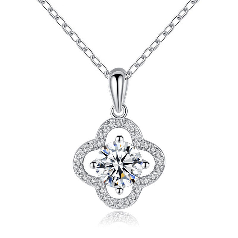 Studio image of four-leaf clover pendant with moissanite center on white background