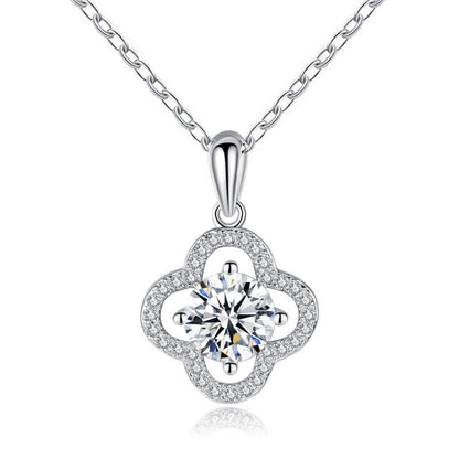 Studio image of four-leaf clover pendant with moissanite center on white background