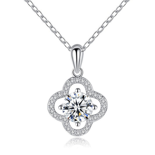 Studio image of four-leaf clover pendant with moissanite center on white background