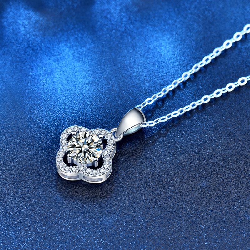 Angled view of clover pendant with moissanite center and CZ halo on chain