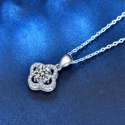 Angled view of clover pendant with moissanite center and CZ halo on chain