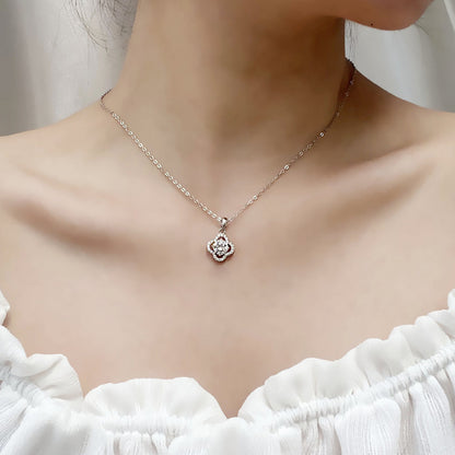Model wearing sterling silver moissanite clover pendant with white top
