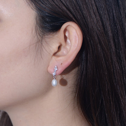 Model wearing sterling silver pearl CZ dangle earrings