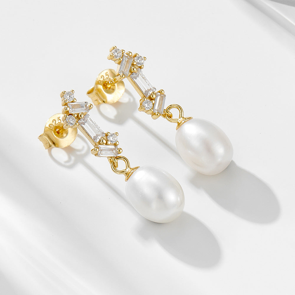 Gold-finish natural pearl dangle earrings with baguette CZ