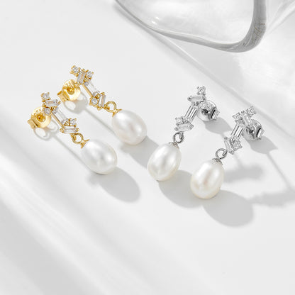 Natural pearl dangle earrings shown in gold and silver finishes