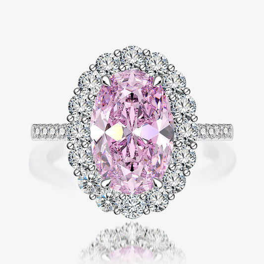 Close-up of pink oval halo CZ ring in rhodium-plated 925 sterling silver with pavé band.