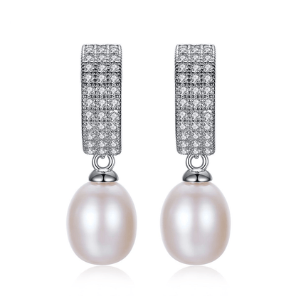 Front view of oval freshwater pearl dangle earrings with pavé CZ in 925 sterling silver.