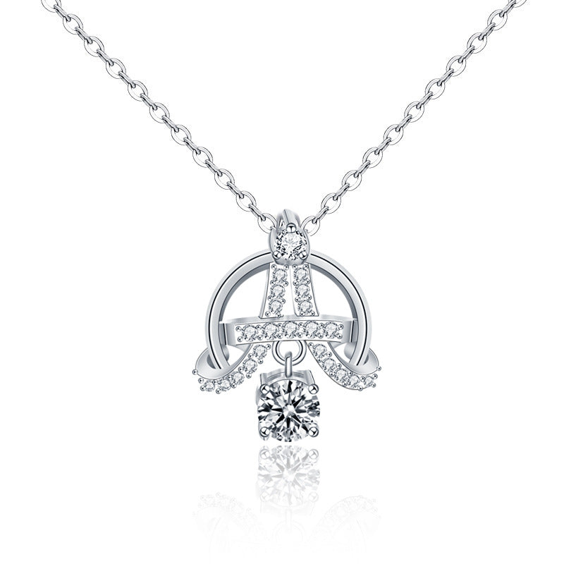 Studio shot of Eiffel-inspired pendant necklace in sterling silver with moissanite and CZ stones.