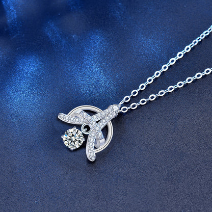 Angled view of sterling silver Eiffel-inspired pendant with sparkling moissanite and CZ stones.
