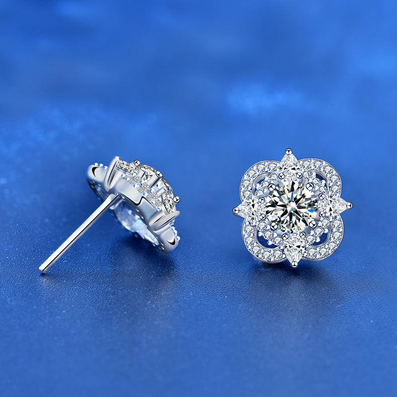 Side angle showing basket setting of quatrefoil moissanite stud in rhodium-plated 925 silver