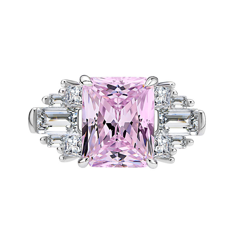 Front view of pink radiant-cut CZ cocktail ring with tapered baguette and round accents in rhodium-plated 925 silver.