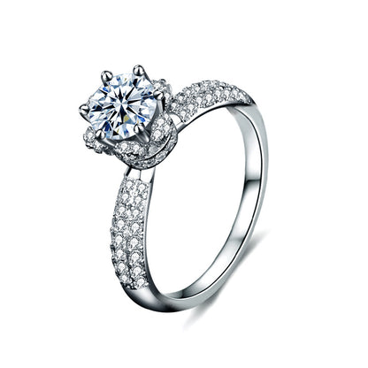 Studio shot of moissanite crown solitaire ring with pavé CZ band, shown on a white background.