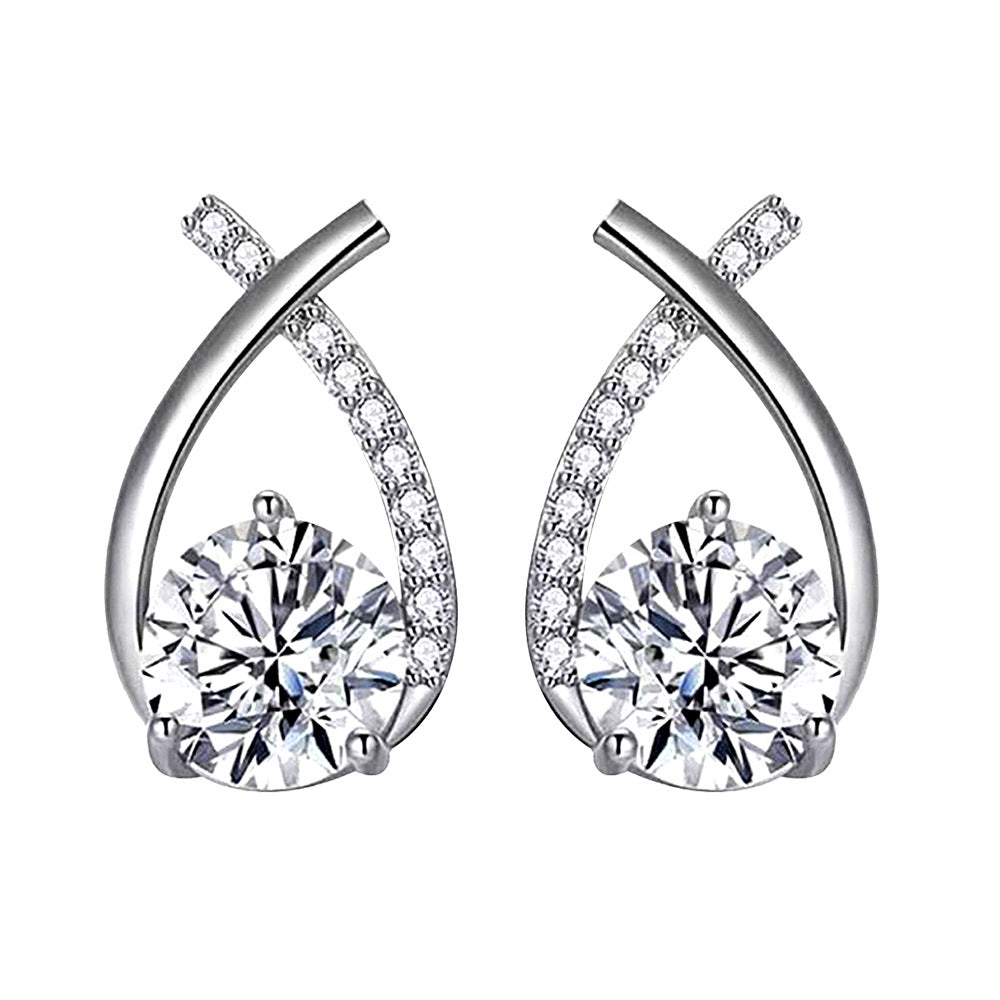 White-background packshot of ribbon-twist moissanite stud earrings in rhodium-plated 925 sterling silver with pavé CZ