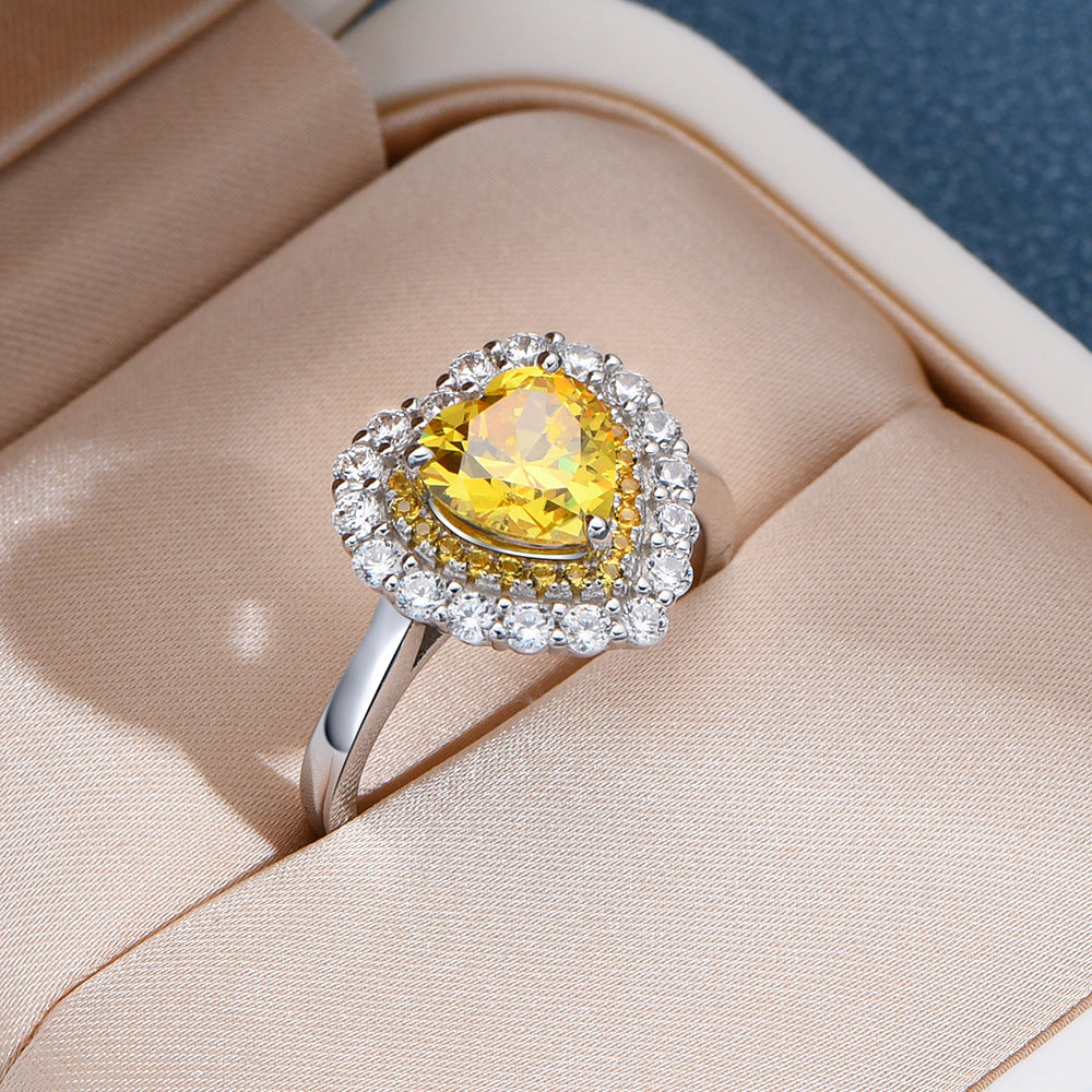 Yellow heart-cut CZ double-halo ring in rhodium-plated sterling silver, displayed in a gift box.