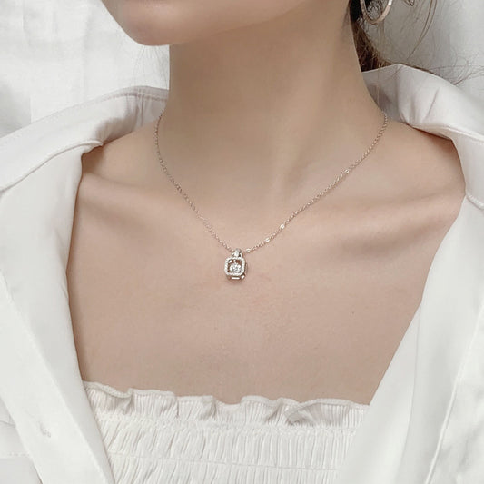 Model wearing sterling silver moissanite padlock pendant necklace.
