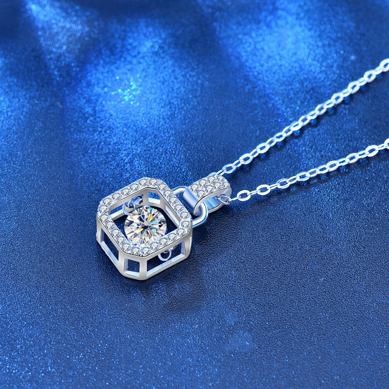 Side view of padlock-inspired moissanite pendant with CZ halo in sterling silver.