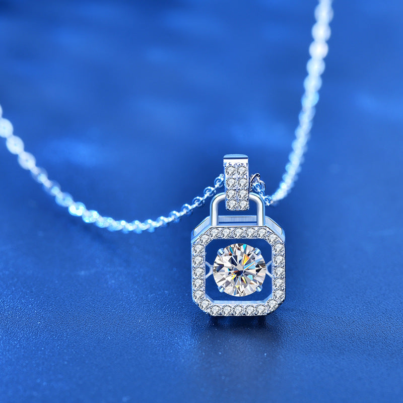 Close-up of moissanite padlock pendant with sparkling CZ halo.