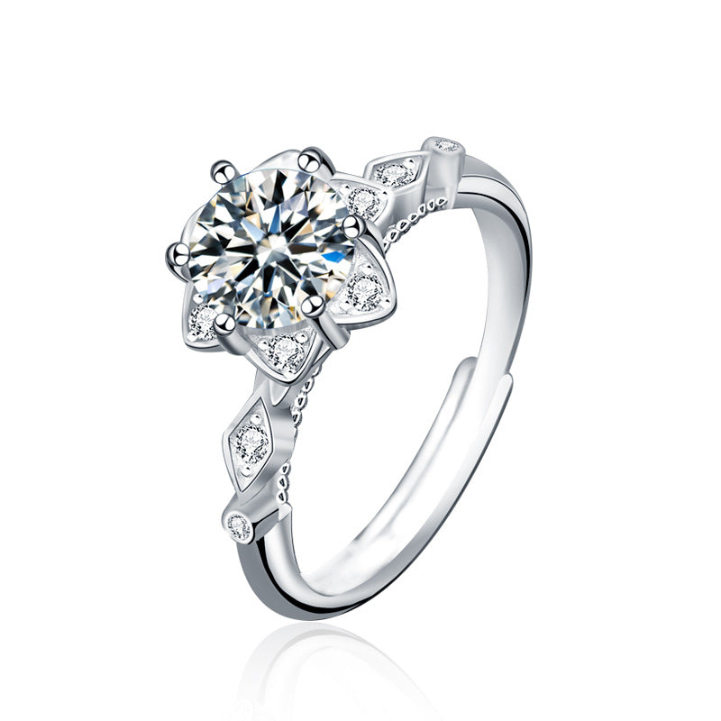 Product cutout of starflower moissanite ring with floral halo and marquise CZ shoulders in rhodium-plated sterling silver.