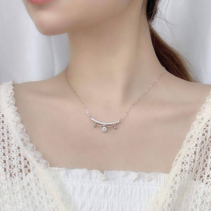 Model wearing delicate sterling silver moissanite lace tassel drop necklace at the collarbone.