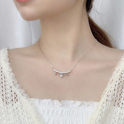 Model wearing delicate sterling silver moissanite lace tassel drop necklace at the collarbone.