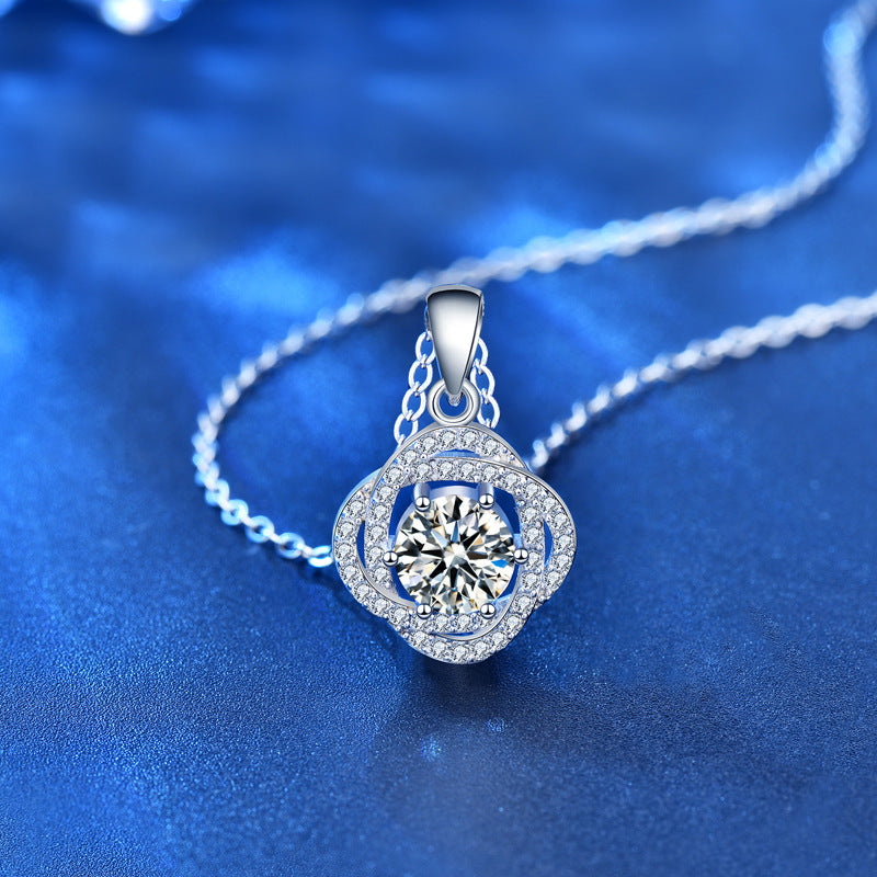 Angled view of moissanite rose flower pendant necklace highlighting four-prong setting and cubic zirconia accents