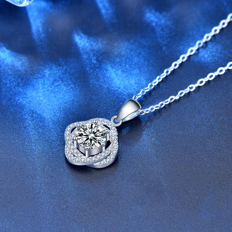 Pendant and chain of moissanite rose flower necklace displayed on blue background, showing shine and craftsmanship