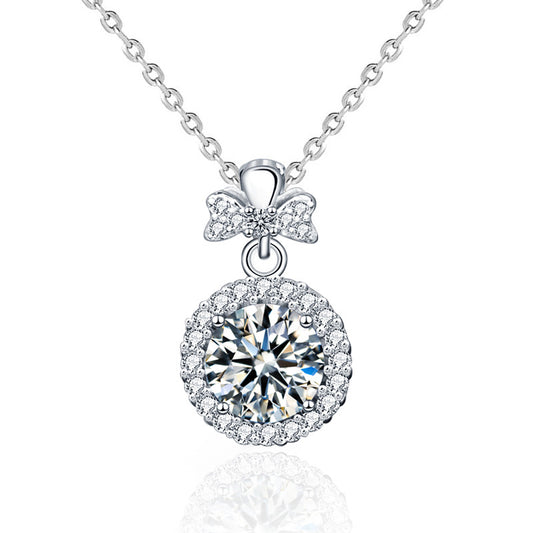 Studio image of moissanite perfume bottle pendant on sterling silver chain against white background