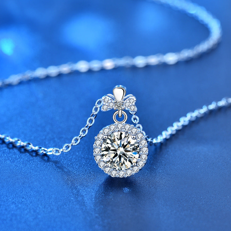 Angled view of moissanite perfume bottle necklace showcasing sparkle and silver chain