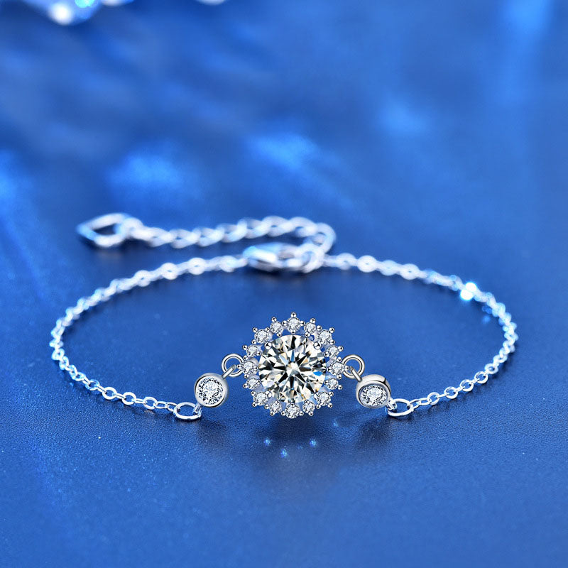Close-up of sunflower moissanite bracelet in sterling silver on blue background