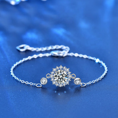 Close-up of sunflower moissanite bracelet in sterling silver on blue background