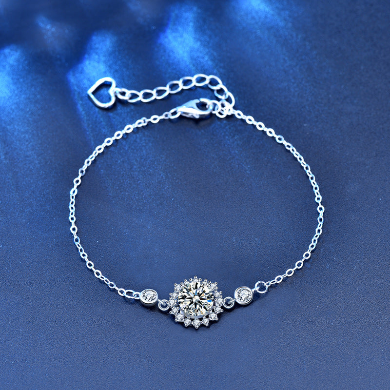 Sterling-silver moissanite sunflower bracelet with heart extender, flat lay