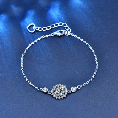 Sterling-silver moissanite sunflower bracelet with heart extender, flat lay