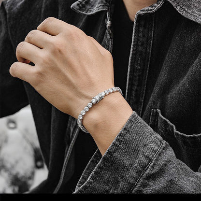 Man wearing silver CZ tennis bracelet with denim jacket, unisex sterling silver design.